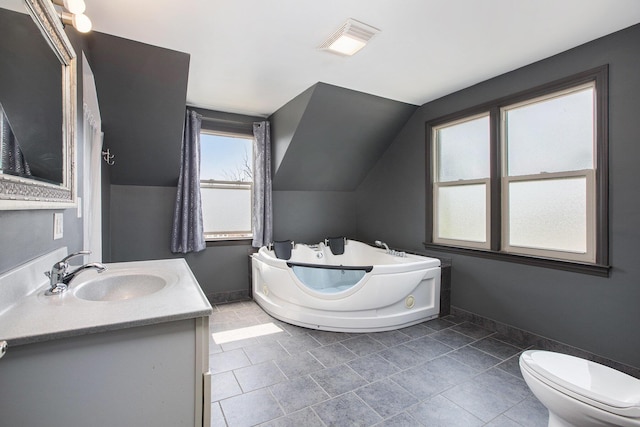 525 Riverview Ave, Monroe, MI 48162 - bathroom featuring a garden tub, vanity, lofted ceiling, toilet, and baseboards