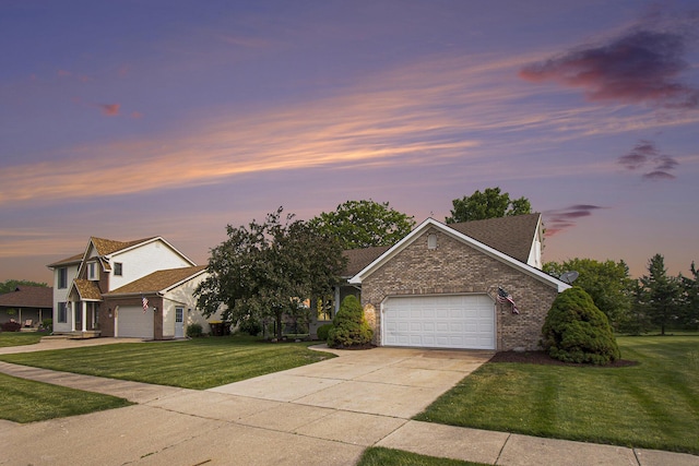743 Fieldview Dr, Grand Ledge, MI 48837 - view of front of house featuring brick siding, concrete driveway, an attached garage, and a yard