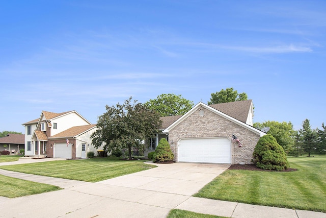 743 Fieldview Dr, Grand Ledge, MI 48837 - view of front facade featuring an attached garage, brick siding, a front yard, and driveway
