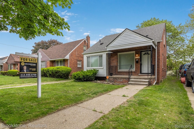 11727 Virgil, Redford, MI 48239 - bungalow-style house with a front lawn, brick siding, roof with shingles, covered porch, and a chimney