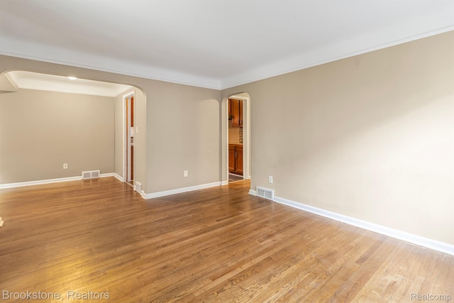 11727 Virgil, Redford, MI 48239 - unfurnished room featuring arched walkways, light wood-type flooring, baseboards, and crown molding