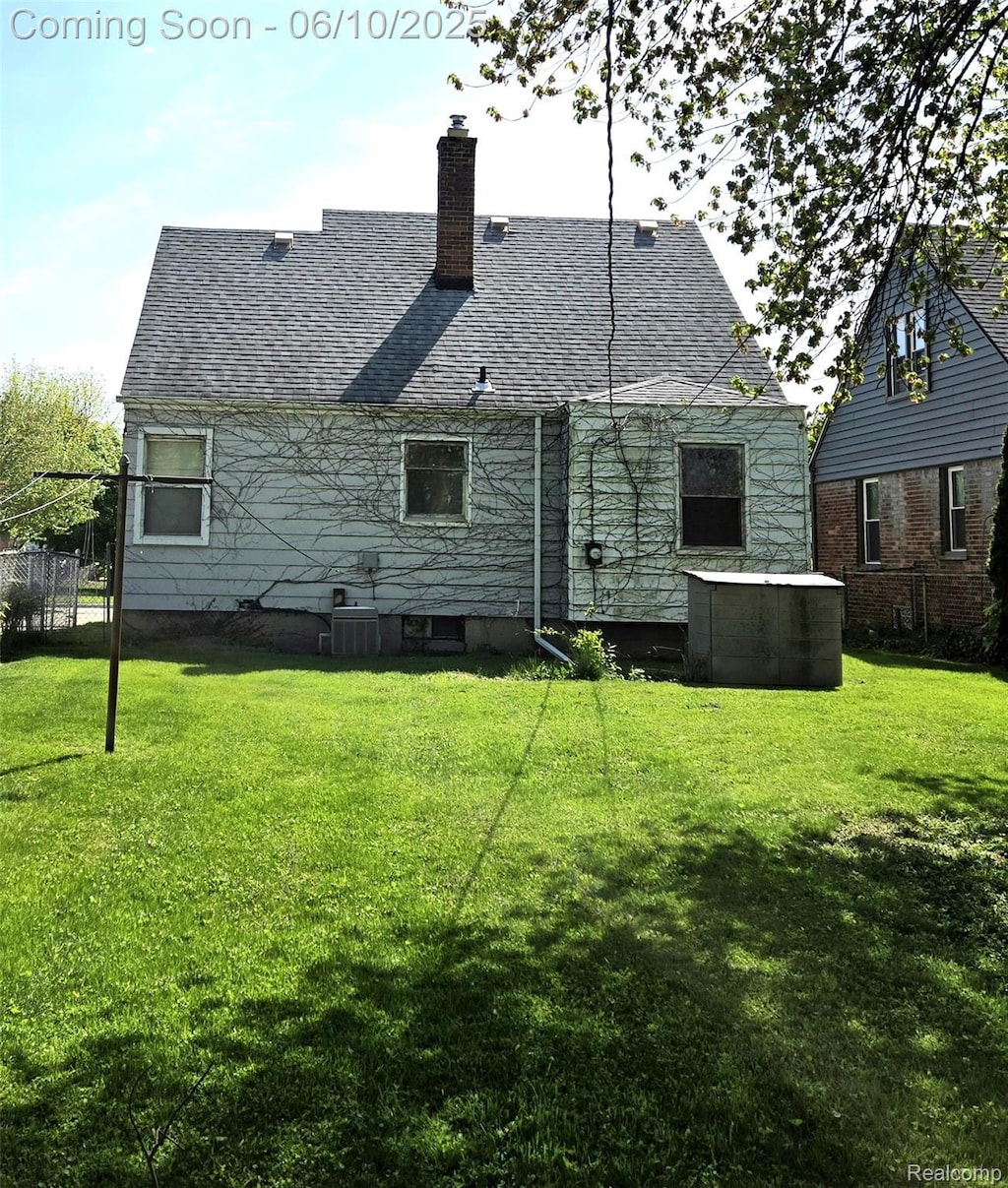 3800 Academy St, Dearborn, MI 48124 - back of property featuring a lawn, a chimney, and a shingled roof