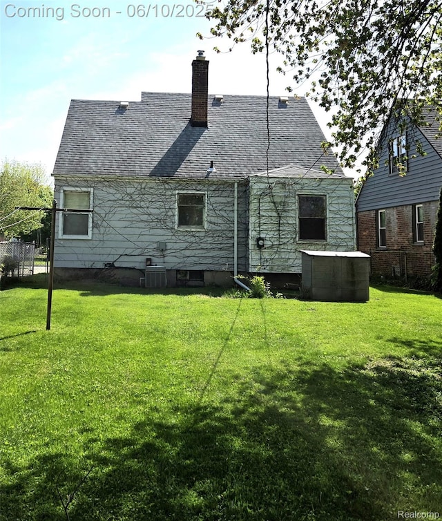 3800 Academy St, Dearborn, MI 48124 - back of property featuring a lawn, a chimney, and a shingled roof