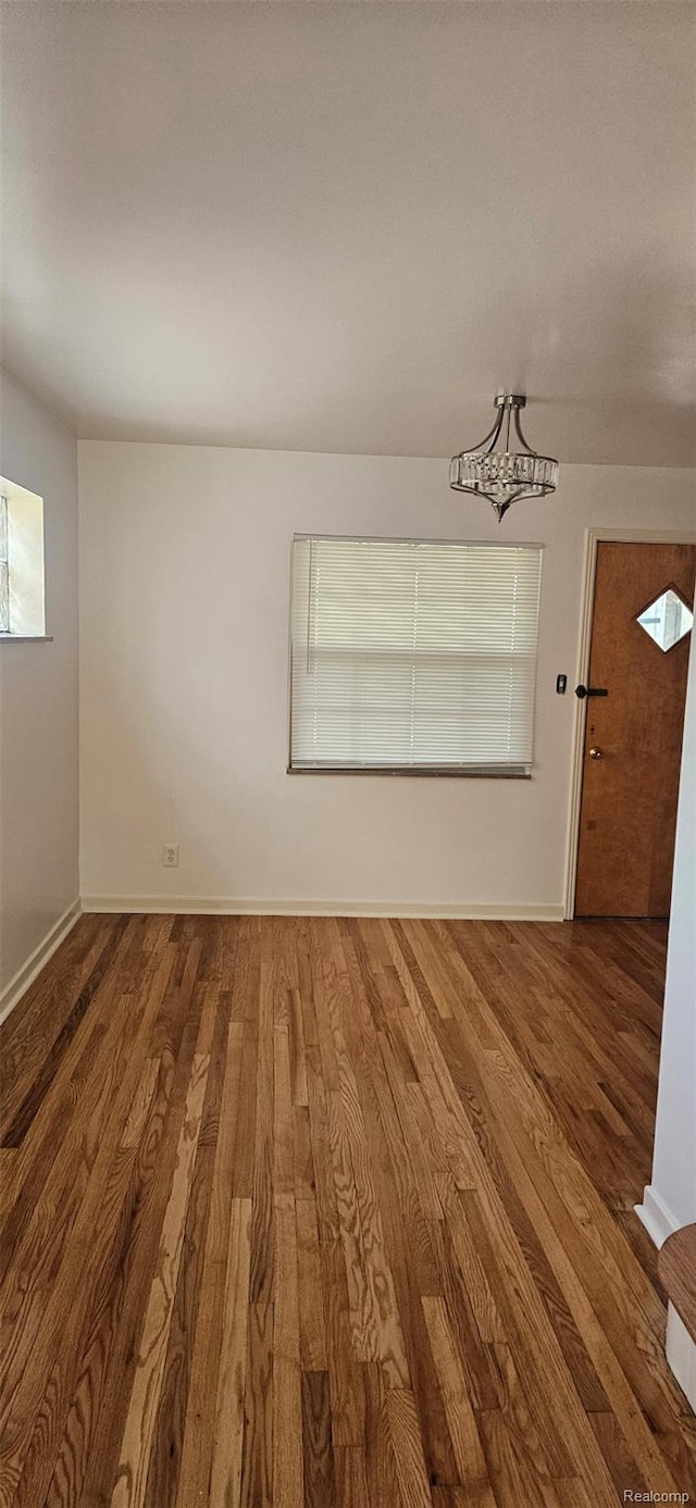 18966 Mendota St, Detroit, MI 48221 - unfurnished room with wood finished floors and a chandelier