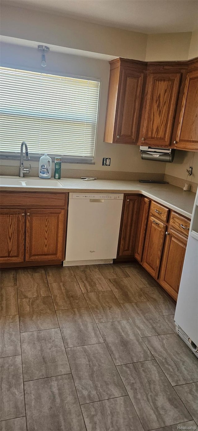 18966 Mendota St, Detroit, MI 48221 - kitchen featuring white dishwasher, light countertops, and brown cabinetry