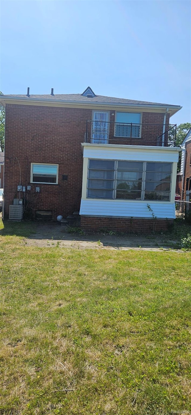 18966 Mendota St, Detroit, MI 48221 - back of property featuring a balcony, a yard, and brick siding