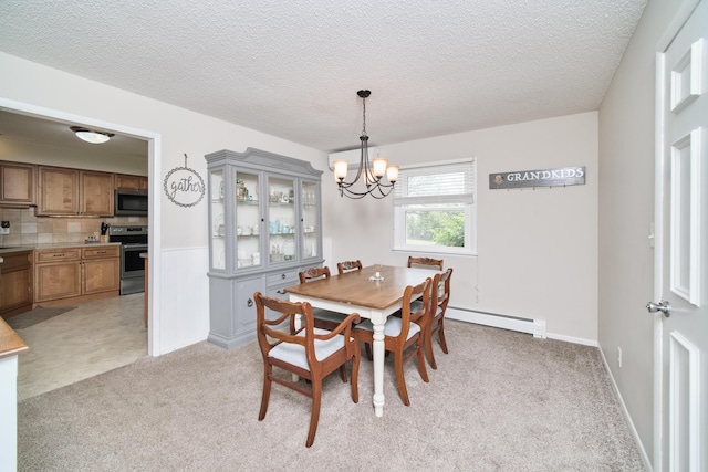 819 Elm St, Manistee, MI 49660 - dining space featuring a baseboard heating unit, a chandelier, light colored carpet, a textured ceiling, and a wainscoted wall