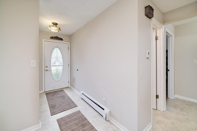 819 Elm St, Manistee, MI 49660 - foyer entrance featuring baseboard heating and baseboards