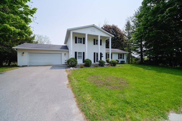 819 Elm St, Manistee, MI 49660 - neoclassical / greek revival house with driveway, an attached garage, and a front lawn