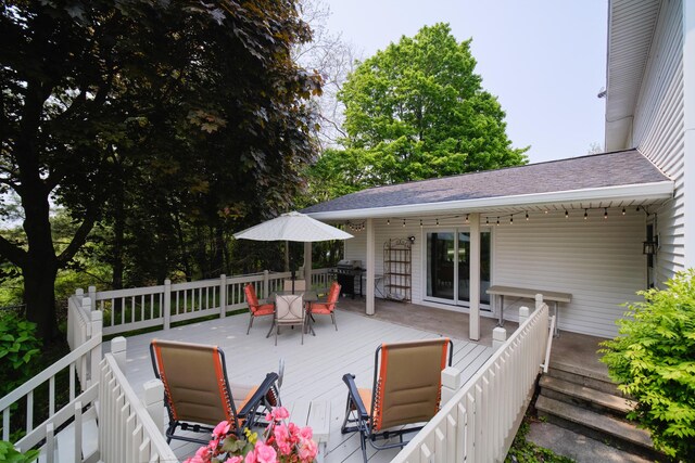 819 Elm St, Manistee, MI 49660 - wooden deck with outdoor dining area