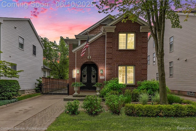 742 Emmons Ave, Birmingham, MI 48009 - view of front of home featuring french doors, brick siding, and a gate