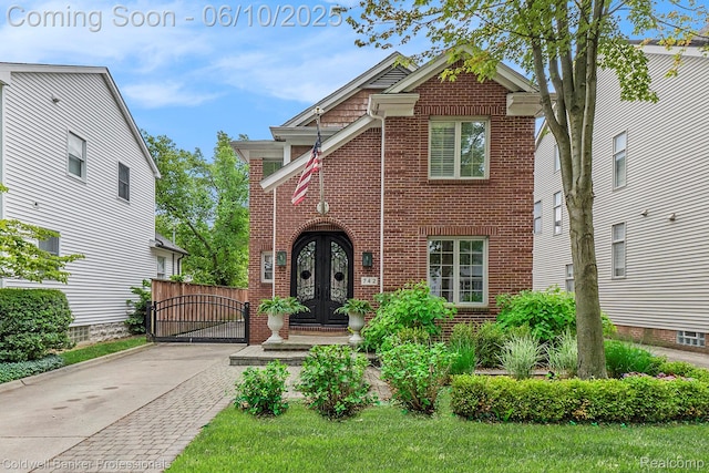 742 Emmons Ave, Birmingham, MI 48009 - view of front of home with brick siding, french doors, and a gate