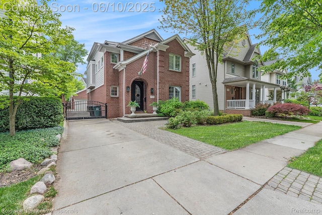 742 Emmons Ave, Birmingham, MI 48009 - view of front of home featuring a gate, brick siding, concrete driveway, and a front yard