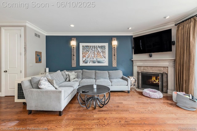 742 Emmons Ave, Birmingham, MI 48009 - living area with ornamental molding, wood finished floors, a high end fireplace, and recessed lighting