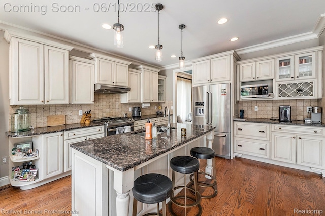 742 Emmons Ave, Birmingham, MI 48009 - kitchen featuring appliances with stainless steel finishes, under cabinet range hood, crown molding, wood finished floors, and decorative backsplash
