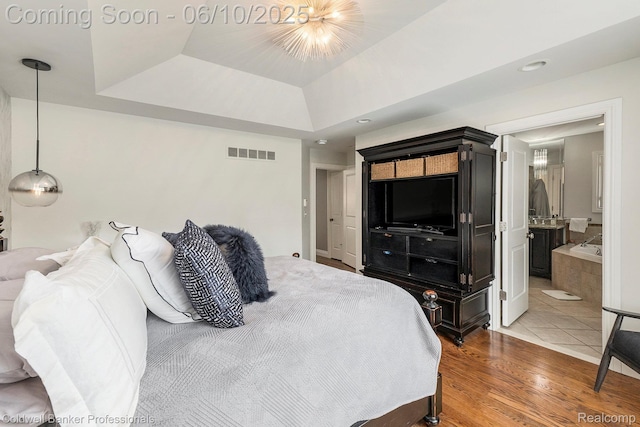 742 Emmons Ave, Birmingham, MI 48009 - bedroom featuring wood finished floors, ensuite bath, a tray ceiling, and recessed lighting