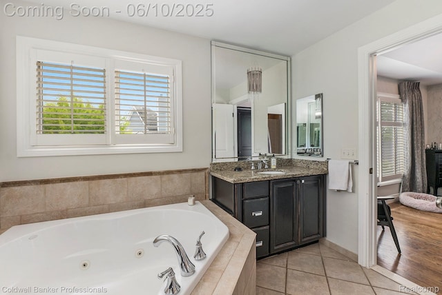 742 Emmons Ave, Birmingham, MI 48009 - bathroom featuring vanity, a tub with jets, and tile patterned floors