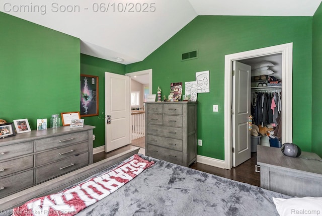 742 Emmons Ave, Birmingham, MI 48009 - bedroom with vaulted ceiling, baseboards, dark wood-style floors, a closet, and a walk in closet