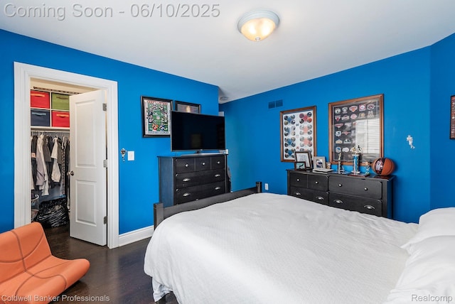 742 Emmons Ave, Birmingham, MI 48009 - bedroom featuring wood finished floors, a walk in closet, a closet, and baseboards