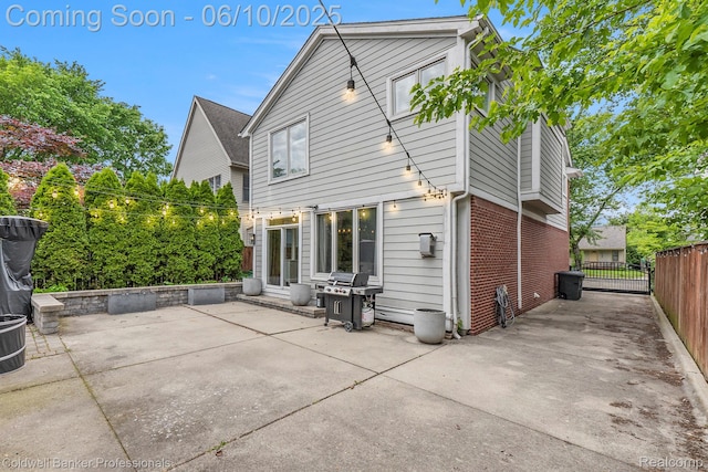 742 Emmons Ave, Birmingham, MI 48009 - rear view of house featuring a patio area, brick siding, and a gate