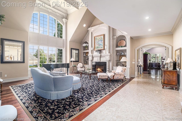 11384 Scarborough Dr, Shelby Twp, MI 48315 - living room with arched walkways, recessed lighting, a lit fireplace, crown molding, and a high ceiling