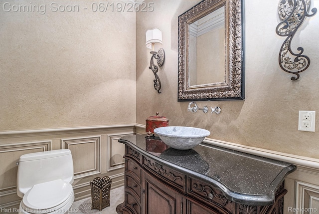 11384 Scarborough Dr, Shelby Twp, MI 48315 - half bathroom with vanity, a decorative wall, and wainscoting
