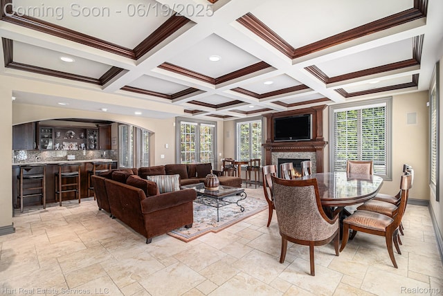 11384 Scarborough Dr, Shelby Twp, MI 48315 - living area with healthy amount of natural light, bar with sink, arched walkways, a glass covered fireplace, and coffered ceiling