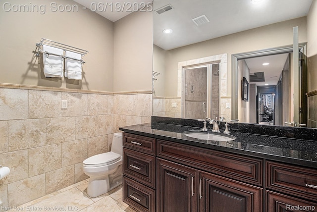 11384 Scarborough Dr, Shelby Twp, MI 48315 - bathroom with tile walls, vanity, wainscoting, and recessed lighting