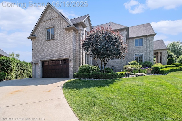 11384 Scarborough Dr, Shelby Twp, MI 48315 - traditional-style house with brick siding, a garage, driveway, and a front yard