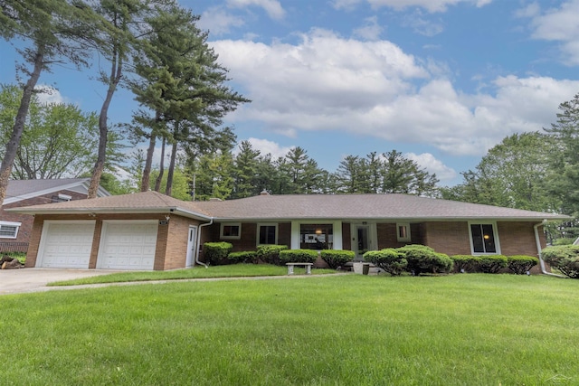 4680 Pinehaven Dr, Saginaw, MI 48638 - ranch-style home with a garage, a front yard, brick siding, and driveway