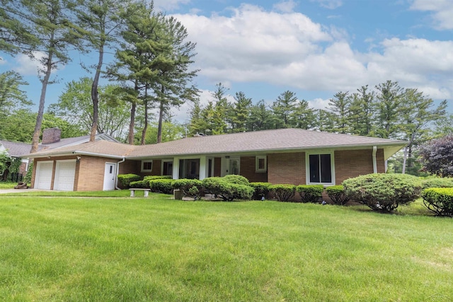 4680 Pinehaven Dr, Saginaw, MI 48638 - ranch-style house featuring an attached garage, brick siding, a front lawn, and a chimney