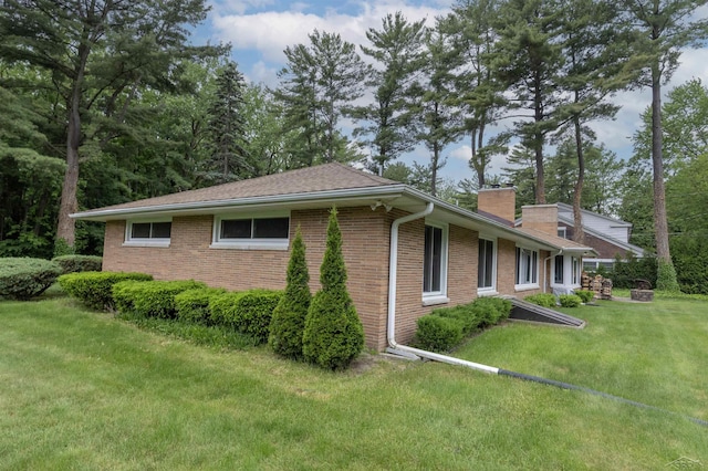 4680 Pinehaven Dr, Saginaw, MI 48638 - view of home's exterior featuring brick siding, a lawn, and a chimney
