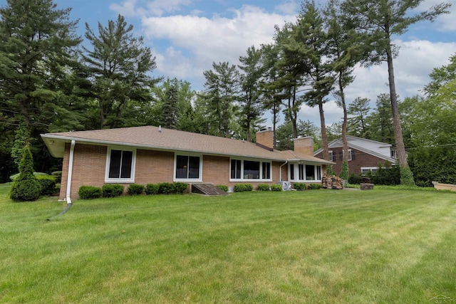 4680 Pinehaven Dr, Saginaw, MI 48638 - view of front of property with a chimney, brick siding, and a front yard