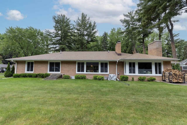 4680 Pinehaven Dr, Saginaw, MI 48638 - ranch-style home featuring a chimney, brick siding, a front lawn, and roof with shingles