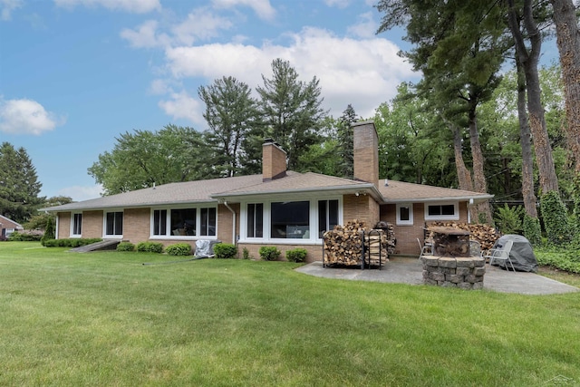 4680 Pinehaven Dr, Saginaw, MI 48638 - back of property featuring a patio, a chimney, brick siding, a yard, and a fire pit