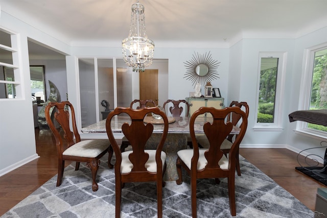 4680 Pinehaven Dr, Saginaw, MI 48638 - dining space with a chandelier, dark wood-style floors, and baseboards