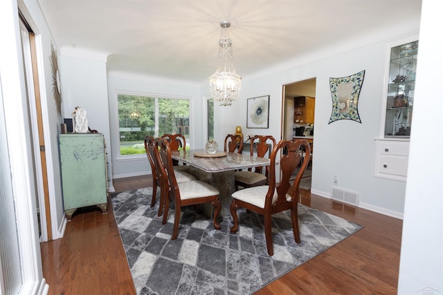 4680 Pinehaven Dr, Saginaw, MI 48638 - dining area featuring a chandelier, wood finished floors, and baseboards