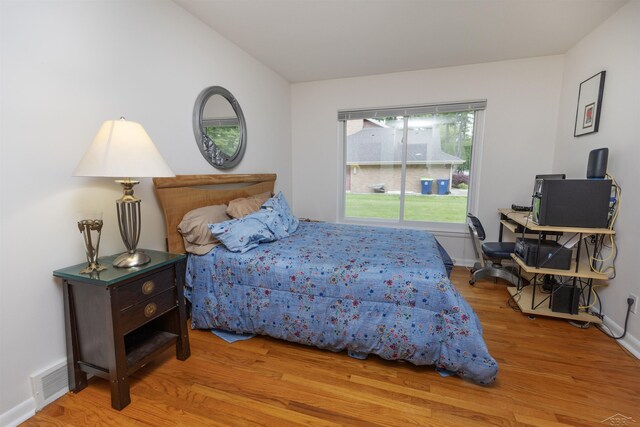 4680 Pinehaven Dr, Saginaw, MI 48638 - bedroom with wood finished floors, baseboards, and lofted ceiling