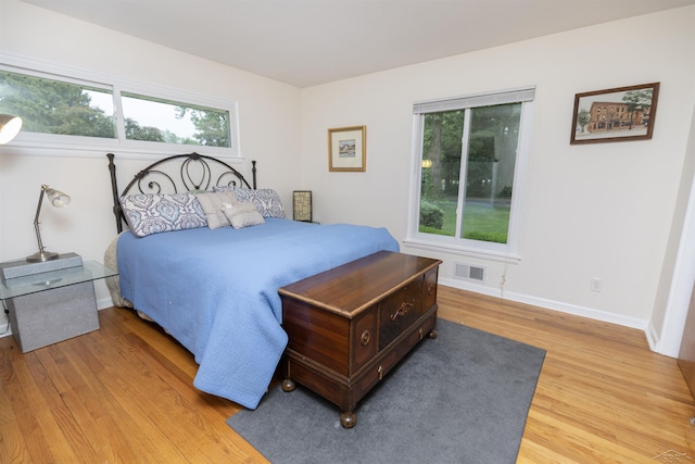 4680 Pinehaven Dr, Saginaw, MI 48638 - bedroom featuring light wood-style flooring, multiple windows, and baseboards