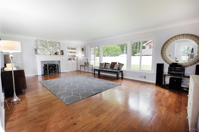 4680 Pinehaven Dr, Saginaw, MI 48638 - living area featuring wood finished floors, a fireplace with flush hearth, and baseboards