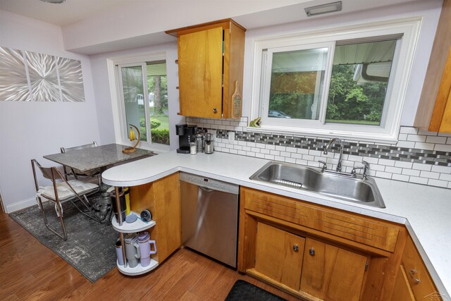 4680 Pinehaven Dr, Saginaw, MI 48638 - kitchen with stainless steel dishwasher, a sink, light countertops, and tasteful backsplash