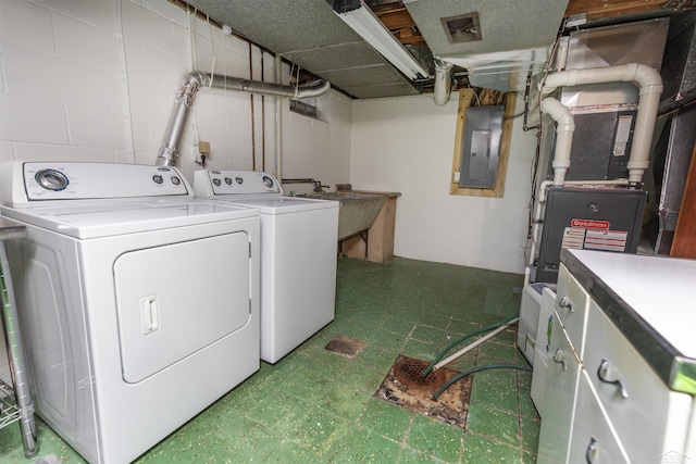 4680 Pinehaven Dr, Saginaw, MI 48638 - laundry area with independent washer and dryer, tile patterned floors, electric panel, and concrete block wall
