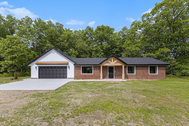 2051 Russell Rd, Muskegon, MI 49445 - view of front of home with board and batten siding, driveway, a garage, a front yard, and brick siding