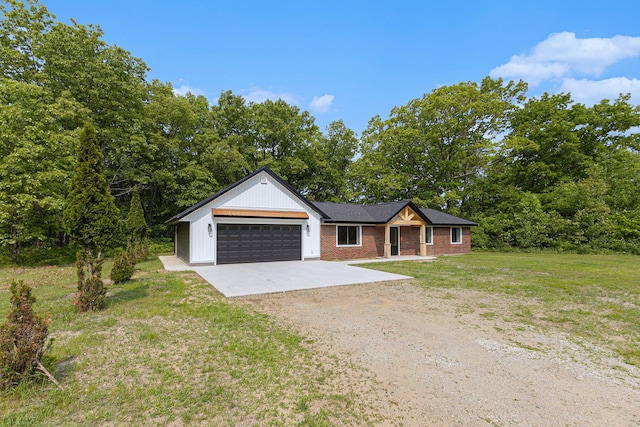 2051 Russell Rd, Muskegon, MI 49445 - view of front of house with driveway, an attached garage, a front lawn, and brick siding