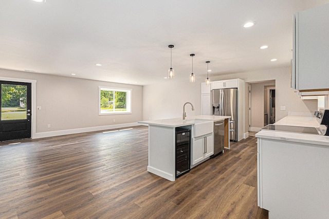 2051 Russell Rd, Muskegon, MI 49445 - kitchen with beverage cooler, appliances with stainless steel finishes, recessed lighting, light countertops, and open floor plan