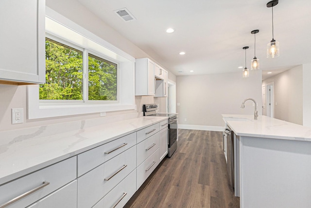 2051 Russell Rd, Muskegon, MI 49445 - kitchen with appliances with stainless steel finishes, dark wood-style floors, light stone counters, white cabinetry, and recessed lighting
