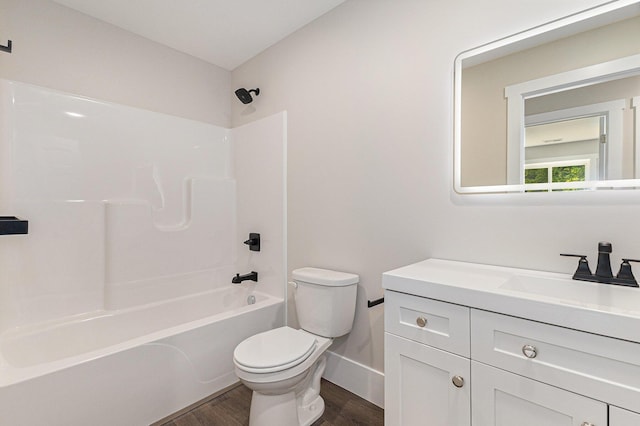 2051 Russell Rd, Muskegon, MI 49445 - full bath featuring toilet, wood finished floors, vanity, tub / shower combination, and baseboards