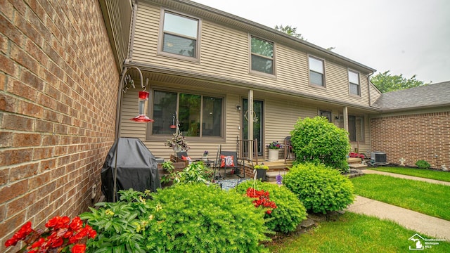 27028 Winchester St, Trenton, MI 48183 - view of front facade with central AC, a front lawn, and a porch
