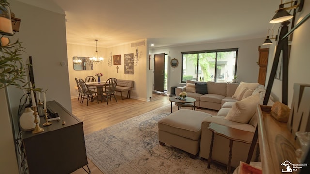 27028 Winchester St, Trenton, MI 48183 - living area featuring a chandelier, light wood-style floors, baseboards, and crown molding