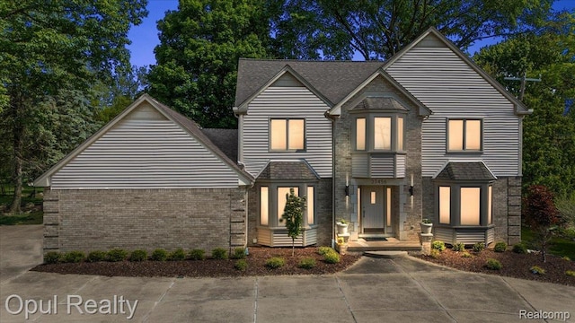 37456 Rhonswood Dr, Northville, MI 48167 - view of front of home with brick siding and roof with shingles